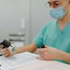 doctor reviewing medical paperwork clipboard CDL truck driver health