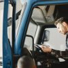 truck driver reading documents cab CDL truck driver health